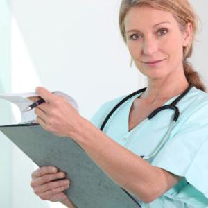 A female nurse viewing a medical chart